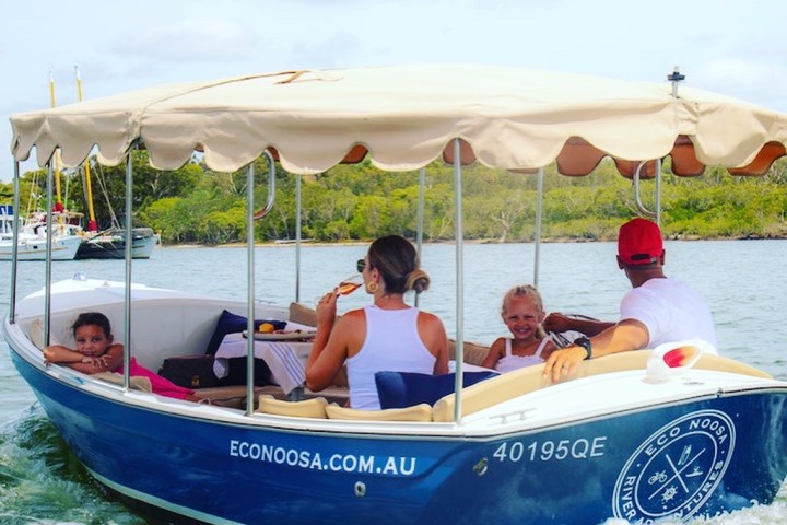 a group of people riding on the back of a boat